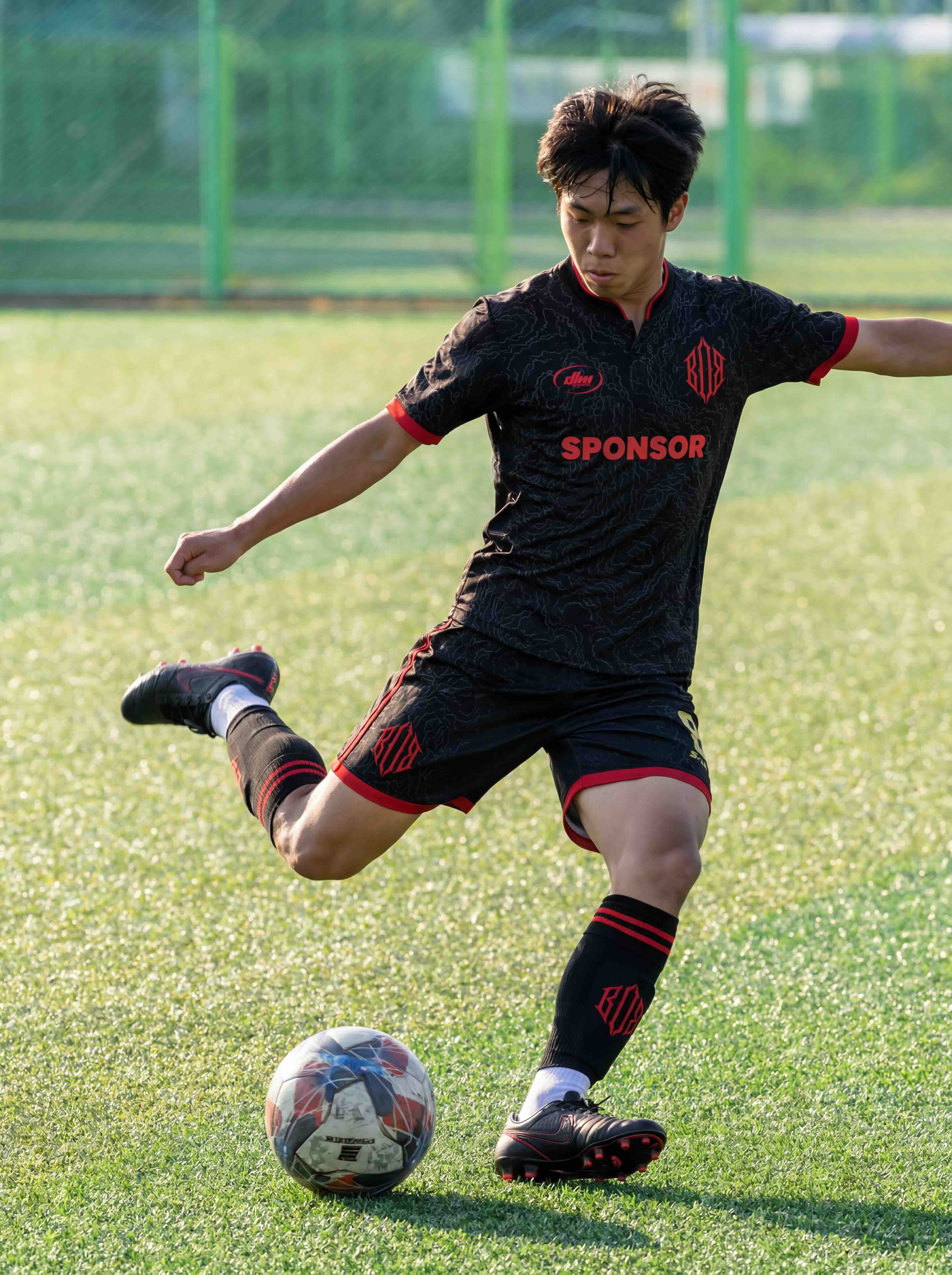BoB x DLM FC player in the home kit with sponsor placement